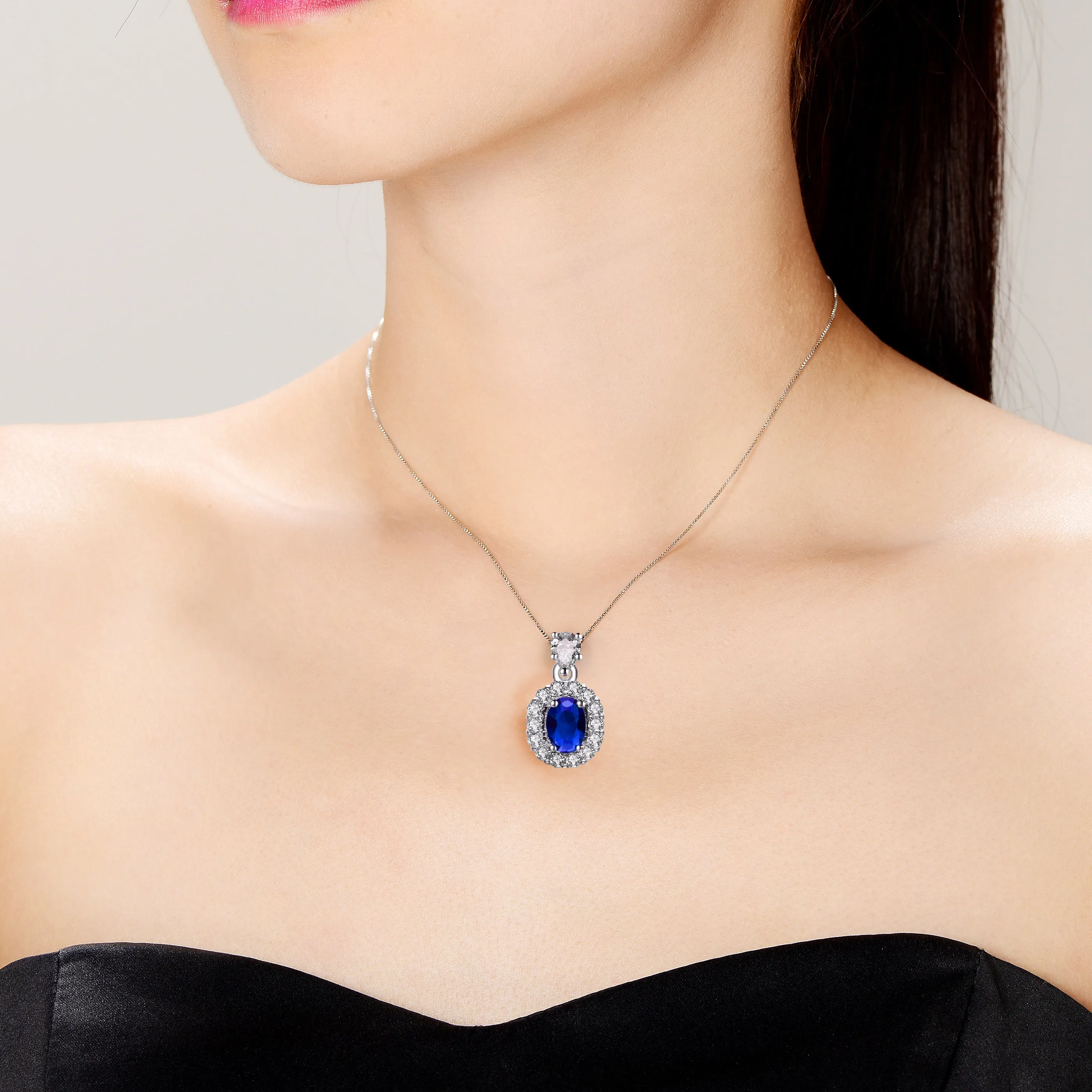 Sterling Silver with Rhodium Plated Sapphire Blue Oval Cubic Zirconia Accented with Clear Pear and Round Cubic Zirconias Necklace